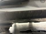 a close up of a car ' s exhaust pipe and exhaust muffler