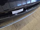 a black car with a sticker on it ' s bumper