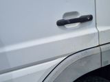a close up of a white van with a flat tire