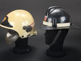 two helmets are sitting on top of each other on a mannequin head