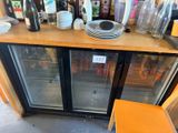 a glass door that has a bunch of bottles on top of it