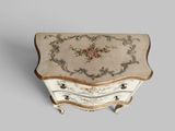 a small chest of drawers with a floral design on it