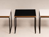 three small tables with black and white tops sit side by side