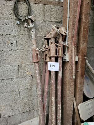 a pile of old pipes and pipes next to a brick wall