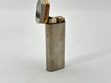 silver lighter on a white background with a lighter in the middle of it