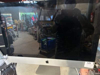 an apple computer monitor sitting on top of a desk in a store