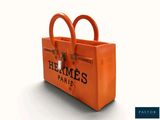 an orange bag with two handles sitting on top of a white surface