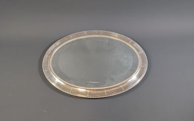 a silver tray with a mirror on it on a table