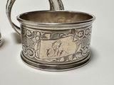 a silver cup that has a handle on it