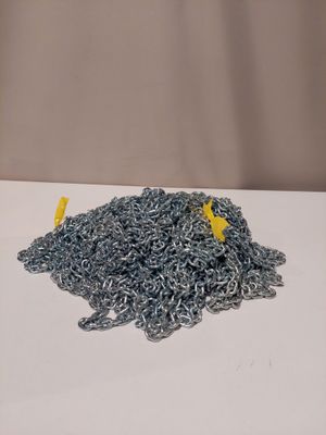 a pile of silver chain on a white table
