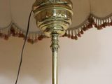 a lamp that is sitting on a table with a lamp shade on it