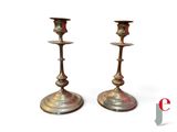 pair of antique brass candlesticks on a white background