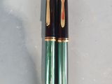 two pens that are sitting on a table