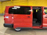 a red van with its door open in a building