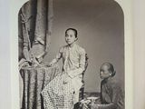 a black and white photo of a man and a woman sitting on a chair