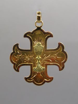 gold plated cross pendant with a crown on top of it