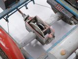 a close up of a machine with a tooth on it ' s side