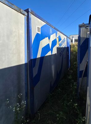 a blue and white sign on the side of a building