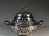an antique silverplated bowl with a lid and handles