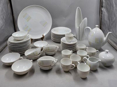 a lot of white dishes and cups on the table