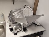 a large slicer sitting on top of a kitchen counter