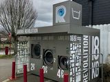 an image of a public laundry machine in a parking lot