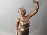 bronze statue of a woman holding a knife and a flower