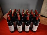 several bottles of red wine are lined up on a table