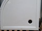 un réfrigérateur blanc posé sur une palette contre un mur