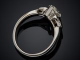 a close up of a diamond ring on a black surface