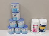 a pile of pills and a bottle of toothpaste on a counter