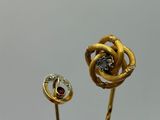pair of gold and diamond flower broochers on a stick