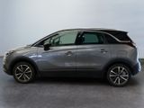 the grey car is parked in a large room with a white wall