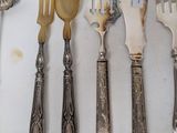 a lot of spoons and forks that are on the table