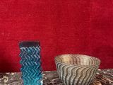 two vases sitting on a table with a red background