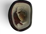 a glass bowl with a brown object inside of it