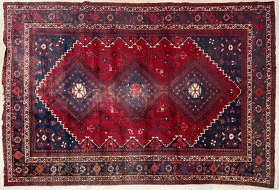 a red and blue rug with a diamond design on it