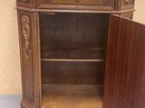 a wooden cabinet with a door open on the floor