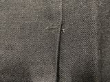 the back of a black jacket with a yellow tie on a mannequin mannequin mannequin mannequin mannequin mannequin manne
