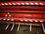 a close up of a row of red farm implements