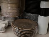 many plates and cups on a shelf in the kitchen