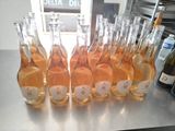 bottles of wine are lined up on a table in a kitchen