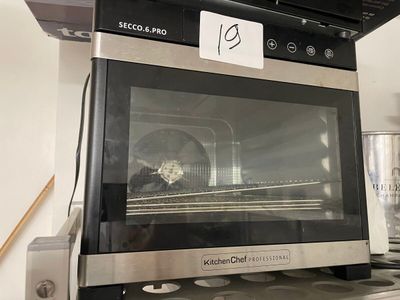a black and silver oven sitting on top of a stove
