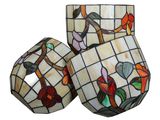 three stained glass vases with birds and flowers on them