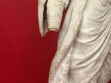 a statue of a woman holding a basket in her hand