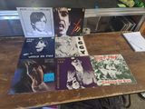 a lot of records sitting on a table in a room