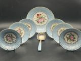six blue and white china plates and a spoon on a table