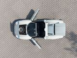 overhead view of a white sports car parked in a parking lot