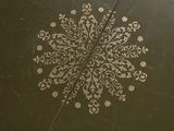 a white snowflake on the floor of a bathroom