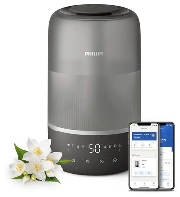 a gray humider next to a cell phone and a flower